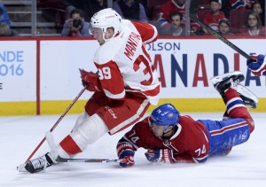 Mar 29, 2016; Montreal, Quebec, CAN; Detroit Red Wings forward Anthony Mantha (39) plays the puck and Montreal Canadiens defenseman Alexei Emelin (74) defends during the third period at the Bell Centre. Mandatory Credit: Eric Bolte-USA TODAY Sports