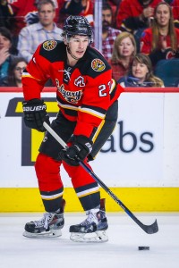 Apr 7, 2016; Calgary, Alberta, CAN; Calgary Flames center Sean Monahan (23) controls the puck against the Vancouver Canucks during the second period at Scotiabank Saddledome. Calgary Flames won 7-3. Mandatory Credit: Sergei Belski-USA TODAY Sports