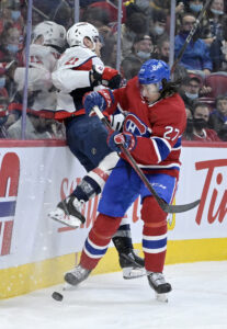 Montreal Canadiens defenseman Alexander Romanov (27) avoids a hit by Washington Capitals forward Garnet Hathaway (21) during the third period at the Bell Centre.